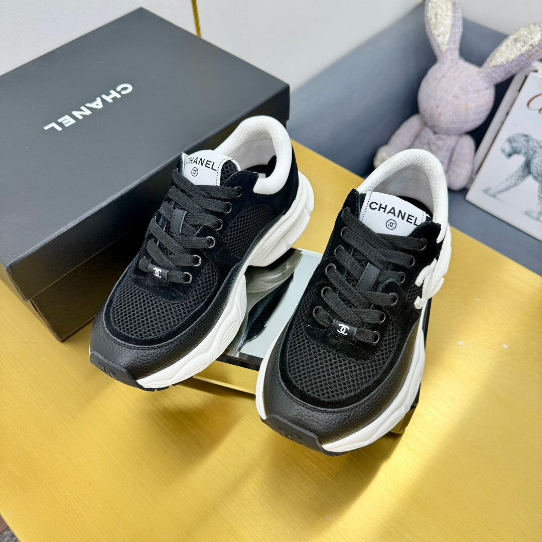 Chanel Sneaker in Black with White Logo Calfskin and Mesh