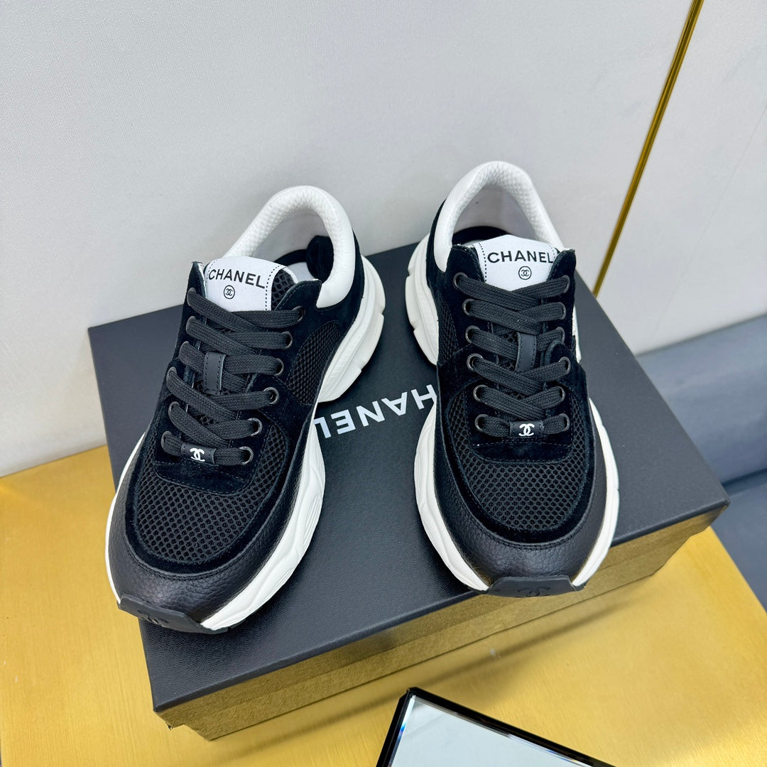 Chanel Sneaker in Black with White Logo Calfskin and Mesh