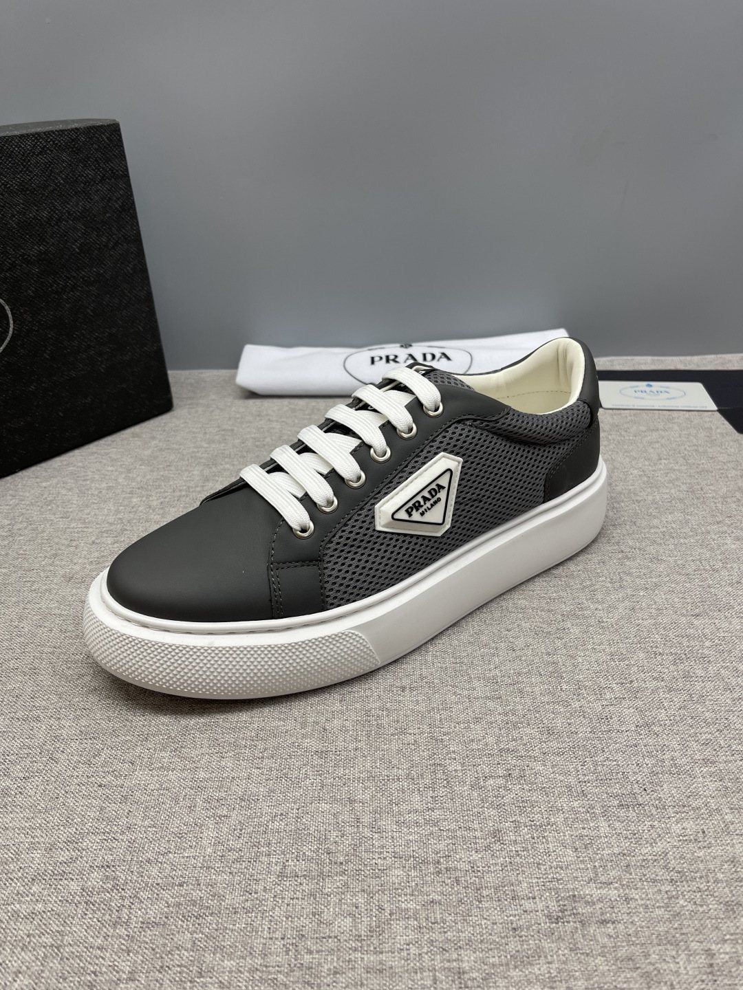 Prada Triangle Patch Low-Top Sneakers — hero